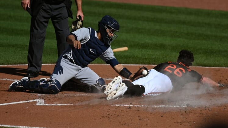 Jun 18, 2022; Baltimore, Maryland, USA; Baltimore Orioles center fielder Ryan McKenna (26) slides past Tampa Bay Rays catcher Francisco Mejia (21) tag to score during the second inning  at Oriole Park at Camden Yards. Mandatory Credit: Tommy Gilligan-USA TODAY Sports