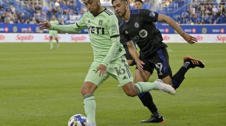 Jun 18, 2022; Montreal, Quebec, CAN; Austin FC midfielder Hector Jimenez (16) plays the ball as CF Montreal midfielder Mathieu Choiniere (29) defends during the first half at Stade Saputo. Mandatory Credit: Eric Bolte-USA TODAY Sports
