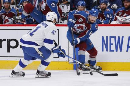 Jun 18, 2022; Denver, Colorado, USA; Colorado Avalanche left wing Andre Burakovsky (95) passes the puck against Tampa Bay Lightning left wing Pierre-Edouard Bellemare (41) during the second period in game two of the 2022 Stanley Cup Final at Ball Arena. Mandatory Credit: Isaiah J. Downing-USA TODAY Sports