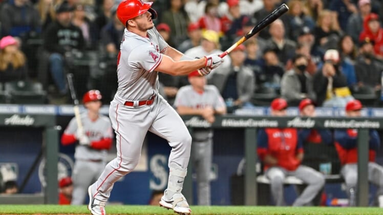 Jun 18, 2022; Seattle, Washington, USA; Los Angeles Angels center fielder Mike Trout (27) hits a home run against the Seattle Mariners during the third inning at T-Mobile Park. Mandatory Credit: Steven Bisig-USA TODAY Sports