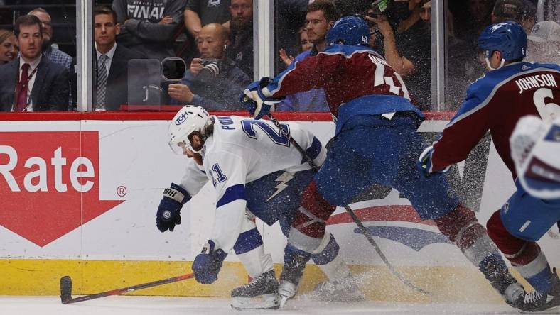 Jun 18, 2022; Denver, Colorado, USA; Colorado Avalanche defenseman Josh Manson (42) hits Tampa Bay Lightning center Brayden Point (21) during the third period in game two of the 2022 Stanley Cup Final at Ball Arena. Mandatory Credit: Isaiah J. Downing-USA TODAY Sports