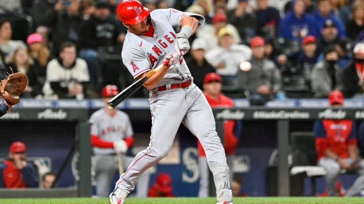 Jun 18, 2022; Seattle, Washington, USA; Los Angeles Angels center fielder Mike Trout (27) hits a single against the Seattle Mariners during the sixth inning at T-Mobile Park. Mandatory Credit: Steven Bisig-USA TODAY Sports