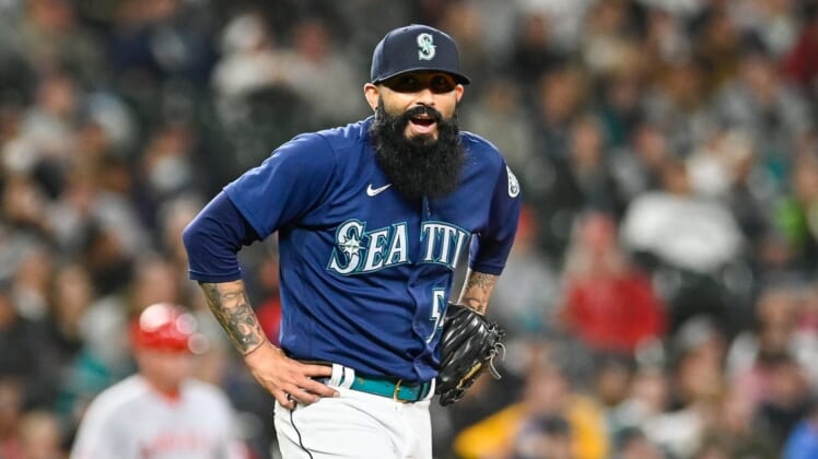 Jun 18, 2022; Seattle, Washington, USA; Seattle Mariners relief pitcher Sergio Romo (54) reacts after giving up a single against the Los Angeles Angels during the seventh inning at T-Mobile Park. Mandatory Credit: Steven Bisig-USA TODAY Sports