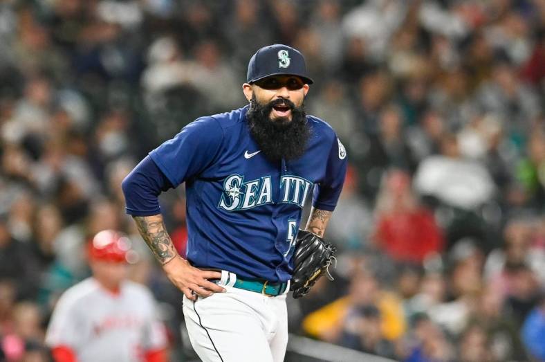 Jun 18, 2022; Seattle, Washington, USA; Seattle Mariners relief pitcher Sergio Romo (54) reacts after giving up a single against the Los Angeles Angels during the seventh inning at T-Mobile Park. Mandatory Credit: Steven Bisig-USA TODAY Sports