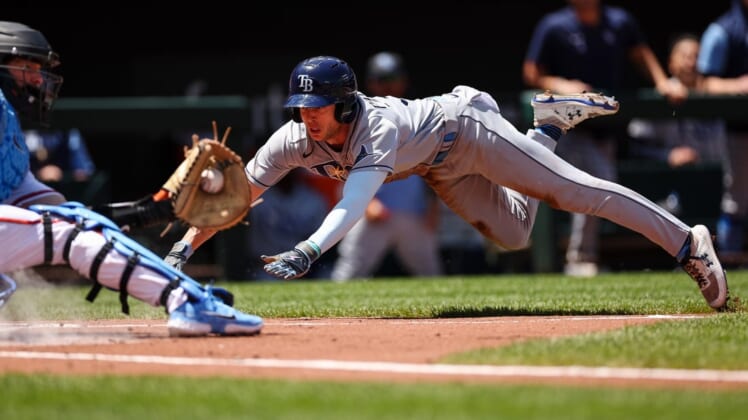 Jun 19, 2022; Baltimore, Maryland, USA; Tampa Bay Rays right fielder Brett Phillips (35) dives before being tagged out by Baltimore Orioles catcher Adley Rutschman (35) during the second inning at Oriole Park at Camden Yards. Mandatory Credit: Scott Taetsch-USA TODAY Sports