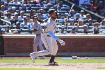 Jun 19, 2022; New York City, New York, USA;  Miami Marlins right fielder Jerar Encarnacion (64) hits a grand slam home run in the seventh inning in his Major League debut against the New York Mets at Citi Field. Mandatory Credit: Wendell Cruz-USA TODAY Sports