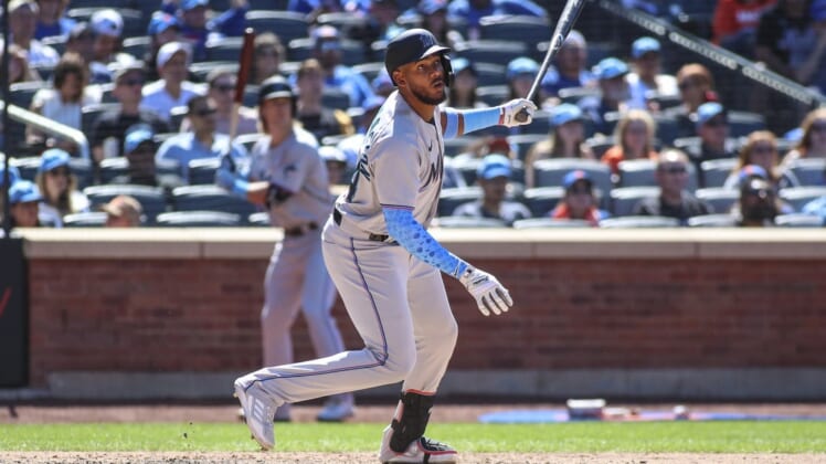 Jun 19, 2022; New York City, New York, USA;  Miami Marlins right fielder Jerar Encarnacion (64) hits a grand slam home run in the seventh inning in his Major League debut against the New York Mets at Citi Field. Mandatory Credit: Wendell Cruz-USA TODAY Sports
