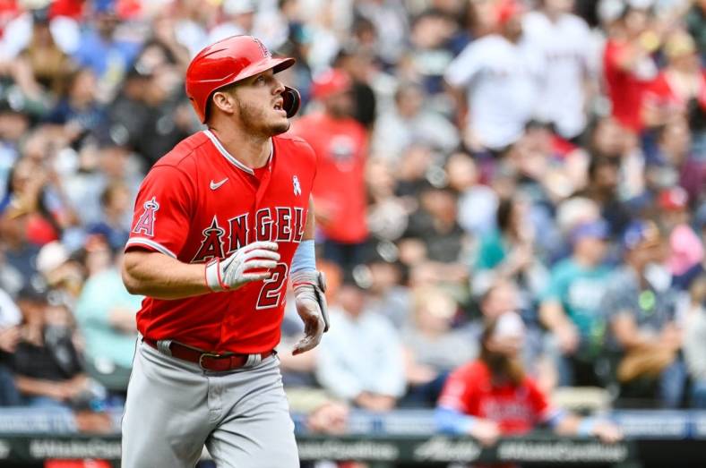 Jun 19, 2022; Seattle, Washington, USA; Los Angeles Angels center fielder Mike Trout (27) runs towards first base after hitting a two-run home run against the Seattle Mariners during the fourth inning at T-Mobile Park. Mandatory Credit: Steven Bisig-USA TODAY Sports