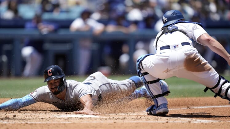 Jun 19, 2022; Los Angeles, California, USA; Cleveland Guardians left fielder Oscar Mercado (35) slides into home plate to beat a throw to Los Angeles Dodgers catcher Will Smith (16) to score in the second inning at Dodger Stadium. Mandatory Credit: Kirby Lee-USA TODAY Sports