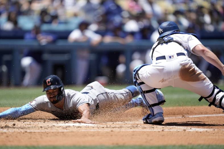 Jun 19, 2022; Los Angeles, California, USA; Cleveland Guardians left fielder Oscar Mercado (35) slides into home plate to beat a throw to Los Angeles Dodgers catcher Will Smith (16) to score in the second inning at Dodger Stadium. Mandatory Credit: Kirby Lee-USA TODAY Sports