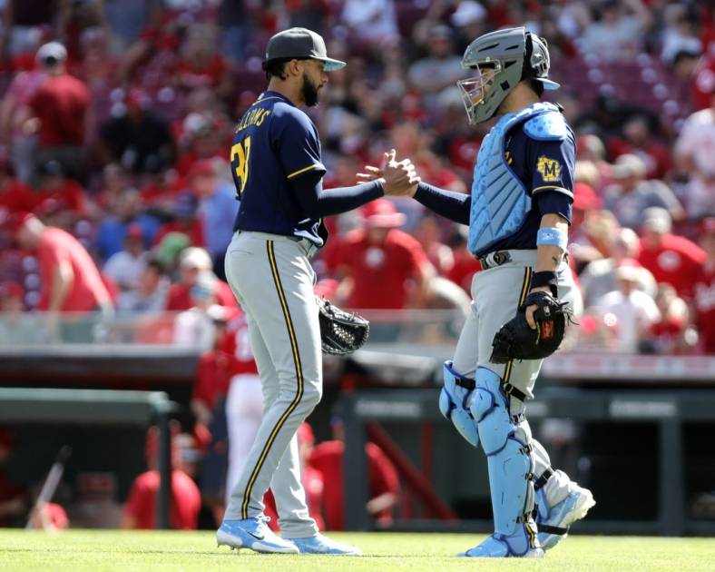 Jun 19, 2022; Cincinnati, Ohio, USA; Milwaukee Brewers closing pitcher Devin Williams (38) reacts with catcher Victor Caratini (7) after the Brewers defeated the Cincinnati Reds at Great American Ball Park. Mandatory Credit: David Kohl-USA TODAY Sports