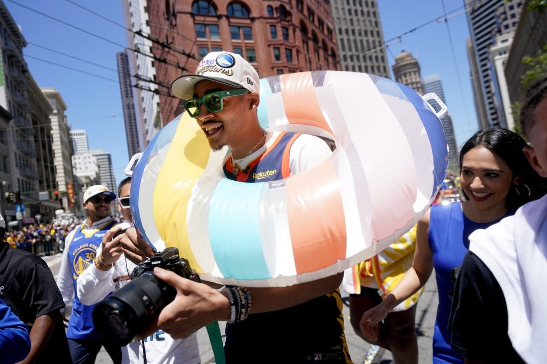 Jun 20, 2022; San Francisco, CA, USA; Golden State Warriors guard Jordan Poole wears a swim tube during the Warriors championship parade in downtown San Francisco. Mandatory Credit: Cary Edmondson-USA TODAY Sports