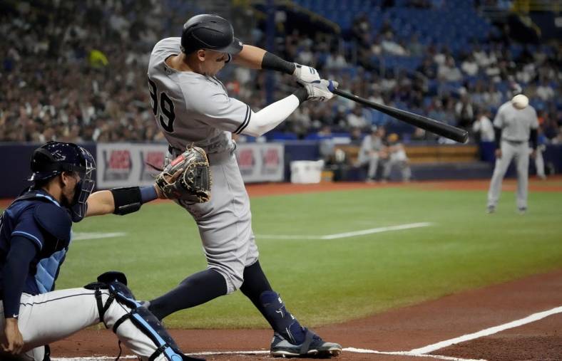 Jun 20, 2022; St. Petersburg, Florida, USA;  New York Yankees right fielder Aaron Judge (99) hits a home run in the first inning against the Tampa Bay Rays at Tropicana Field. Mandatory Credit: Dave Nelson-USA TODAY Sports