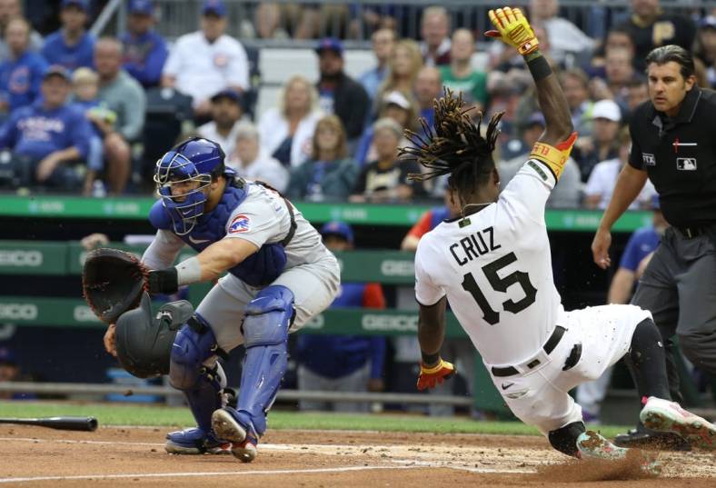 Jun 20, 2022; Pittsburgh, Pennsylvania, USA;  Chicago Cubs catcher Willson Contreras (40) waits for a throw as Pittsburgh Pirates shortstop Oneil Cruz slides home to score a run during the second inning at PNC Park. Mandatory Credit: Charles LeClaire-USA TODAY Sports