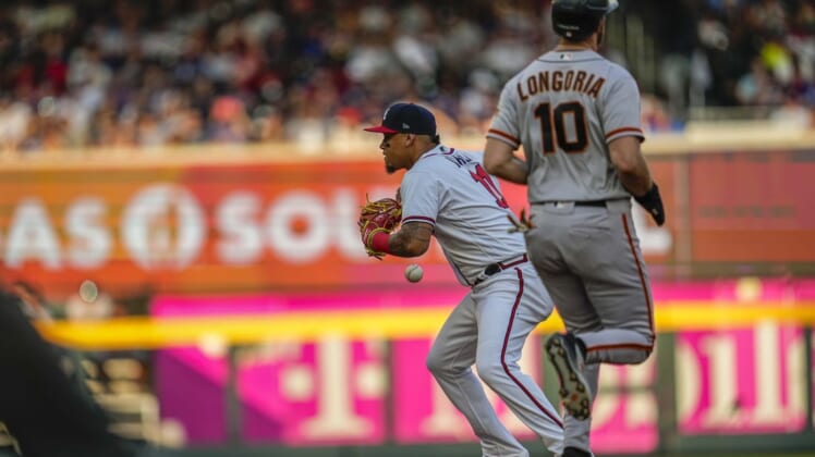 Jun 20, 2022; Cumberland, Georgia, USA; Atlanta Braves second baseman Orlando Arcia (11) mishandles the ball while trying to turn a double play past San Francisco Giants third baseman Evan Longoria (10) during the second inning at Truist Park. Mandatory Credit: Dale Zanine-USA TODAY Sports