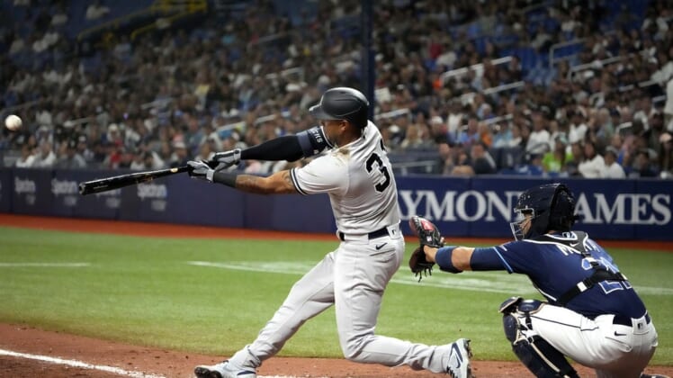 Jun 20, 2022; St. Petersburg, Florida, USA; New York Yankees left fielder Aaron Hicks (31) hits a triple and scores a run against the Tampa Bay Rays during the ninth inning at Tropicana Field. Mandatory Credit: Dave Nelson-USA TODAY Sports