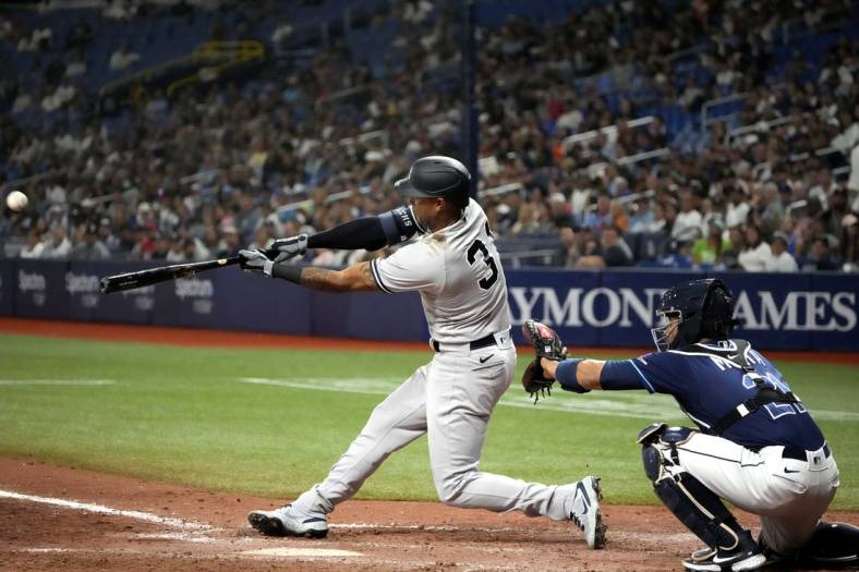 Jun 20, 2022; St. Petersburg, Florida, USA; New York Yankees left fielder Aaron Hicks (31) hits a triple and scores a run against the Tampa Bay Rays during the ninth inning at Tropicana Field. Mandatory Credit: Dave Nelson-USA TODAY Sports