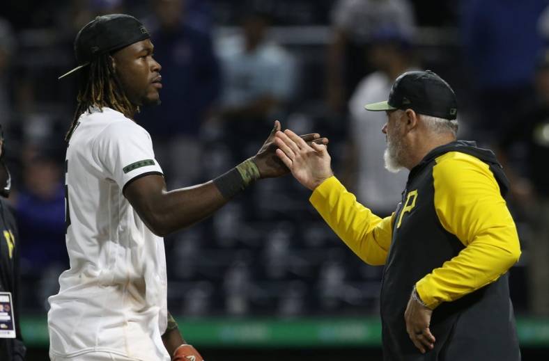 Jun 20, 2022; Pittsburgh, Pennsylvania, USA;  Pittsburgh Pirates shortstop Oneil Cruz (15) and manager Derek Shelton (right) celebrate after defeating the Chicago Cubs at PNC Park. The Pirates won 12-1. Mandatory Credit: Charles LeClaire-USA TODAY Sports