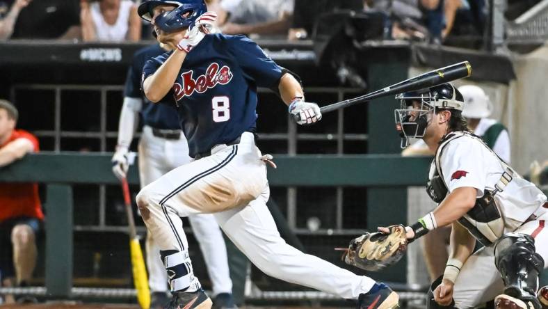 Jun 20, 2022; Omaha, NE, USA;  Ole Miss Rebels center fielder Justin Bench (8) drives in a run against the Arkansas Razorbacks in the eighth inning at Charles Schwab Field. Mandatory Credit: Steven Branscombe-USA TODAY Sports