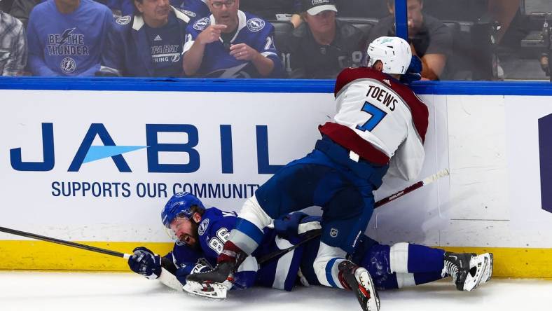 Jun 20, 2022; Tampa, Florida, USA; Colorado Avalanche defenseman Devon Toews (7) checks Tampa Bay Lightning right wing Nikita Kucherov (86) during the third period in game three of the 2022 Stanley Cup Final at Amalie Arena. Mandatory Credit: Mark J. Rebilas-USA TODAY Sports