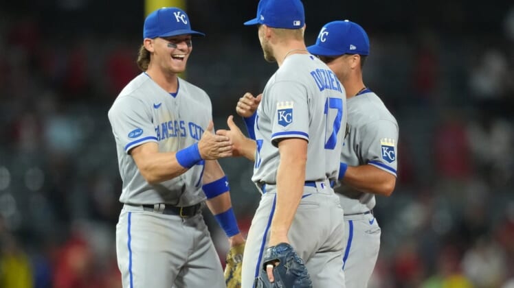 Jun 20, 2022; Anaheim, California, USA; Kansas City Royals shortstop Bobby Witt Jr. (7), first baseman Hunter Dozier (17) and left fielder Whit Merrifield (15) celebrate after the game against the Los Angeles Angels at Angel Stadium. Mandatory Credit: Kirby Lee-USA TODAY Sports