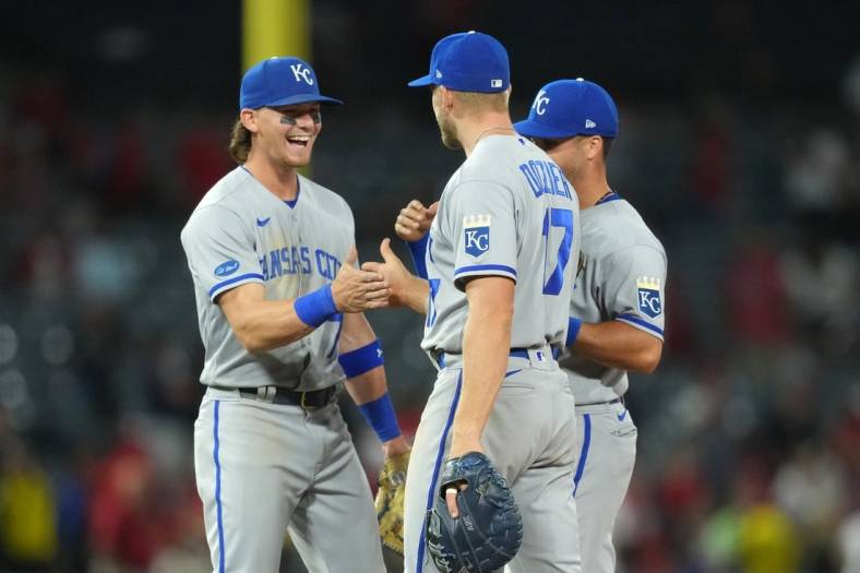 Jun 20, 2022; Anaheim, California, USA; Kansas City Royals shortstop Bobby Witt Jr. (7), first baseman Hunter Dozier (17) and left fielder Whit Merrifield (15) celebrate after the game against the Los Angeles Angels at Angel Stadium. Mandatory Credit: Kirby Lee-USA TODAY Sports