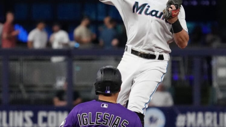 Jun 21, 2022; Miami, Florida, USA; Miami Marlins second baseman Jon Berti (5) gets the force out of Colorado Rockies shortstop Jose Iglesias (11) while turning a double play in the 2nd inning at loanDepot park. Mandatory Credit: Jasen Vinlove-USA TODAY Sports