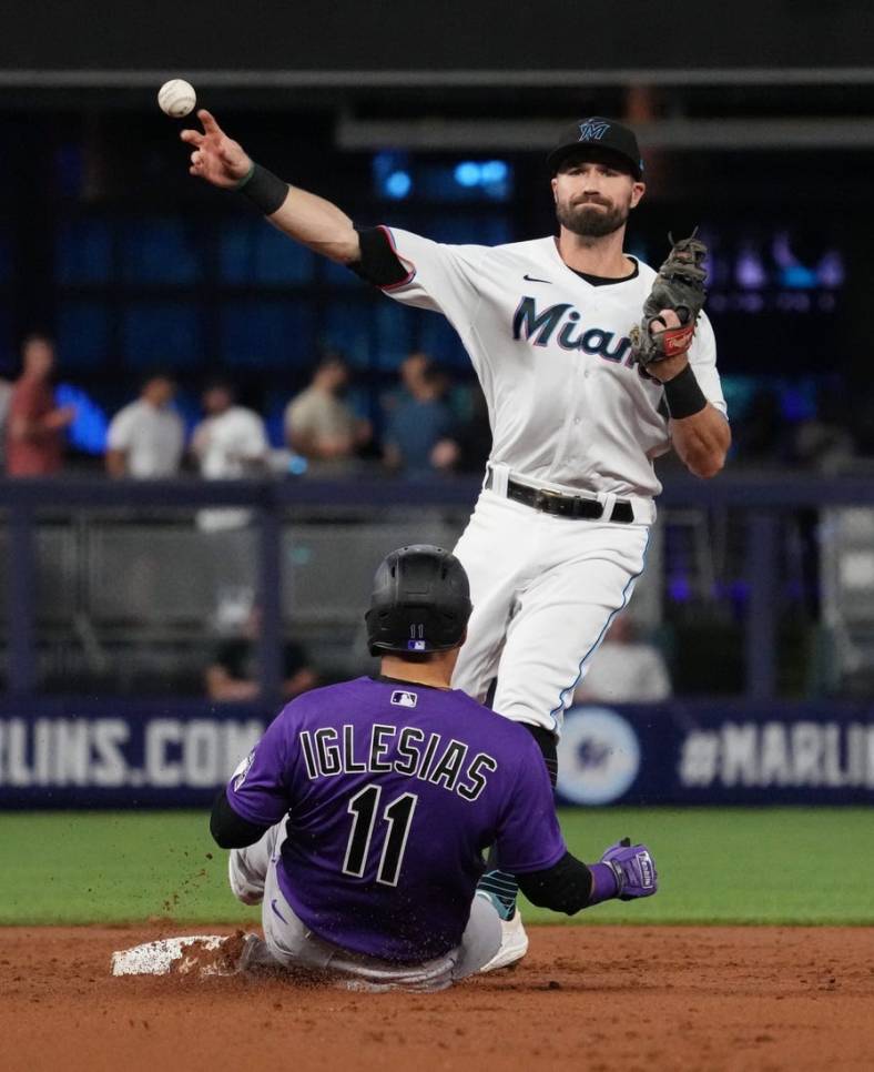 Jun 21, 2022; Miami, Florida, USA; Miami Marlins second baseman Jon Berti (5) gets the force out of Colorado Rockies shortstop Jose Iglesias (11) while turning a double play in the 2nd inning at loanDepot park. Mandatory Credit: Jasen Vinlove-USA TODAY Sports