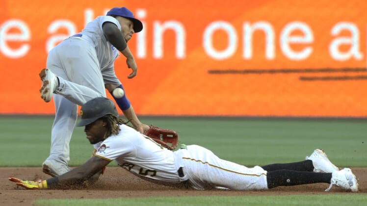 Jun 21, 2022; Pittsburgh, Pennsylvania, USA;  Pittsburgh Pirates shortstop Oneil Cruz (15) steals second base as Chicago Cubs second baseman Andrelton Simmons (19) reaches for the throw during the third inning at PNC Park. Mandatory Credit: Charles LeClaire-USA TODAY Sports