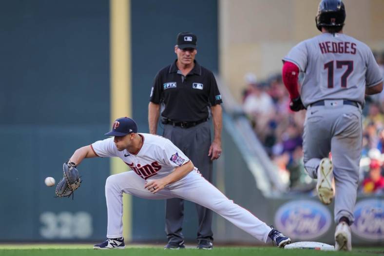 Jun 21, 2022; Minneapolis, Minnesota, USA; Minnesota Twins left fielder Alex Kirilloff (19) catches the ball for an out against the Cleveland Guardians catcher Austin Hedges (17) in the second inning at Target Field. Mandatory Credit: Brad Rempel-USA TODAY Sports