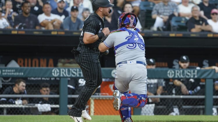 Jun 21, 2022; Chicago, Illinois, USA; Toronto Blue Jays catcher Alejandro Kirk (30) tags out Chicago White Sox second baseman Danny Mendick (20) during the third inning at Guaranteed Rate Field. Mandatory Credit: Kamil Krzaczynski-USA TODAY Sports