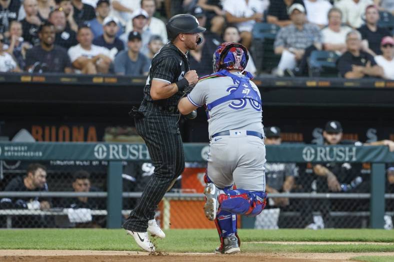 Jun 21, 2022; Chicago, Illinois, USA; Toronto Blue Jays catcher Alejandro Kirk (30) tags out Chicago White Sox second baseman Danny Mendick (20) during the third inning at Guaranteed Rate Field. Mandatory Credit: Kamil Krzaczynski-USA TODAY Sports