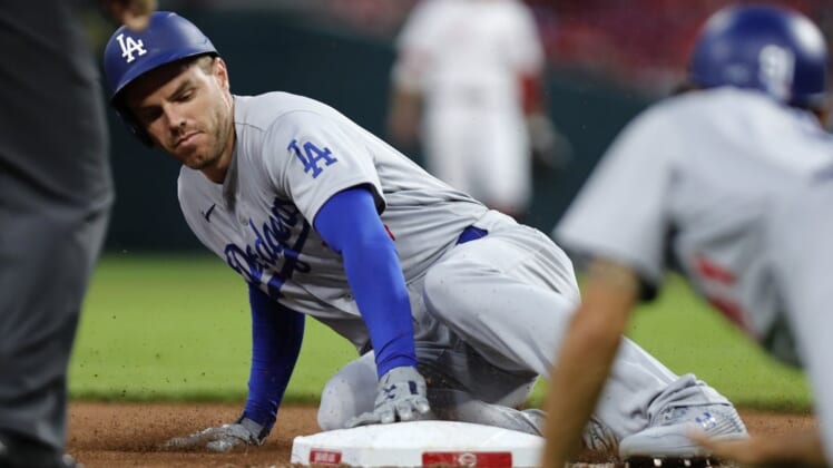 Jun 21, 2022; Cincinnati, Ohio, USA; Los Angeles Dodgers first baseman Freddie Freeman (5) slides safely into third base after hitting a three-run triple against the Cincinnati Reds during the eighth inning at Great American Ball Park. Mandatory Credit: David Kohl-USA TODAY Sports