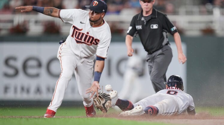 Jun 21, 2022; Minneapolis, Minnesota, USA; Cleveland Guardians second baseman Andres Gimenez (0) steals second against the Minnesota Twins second baseman Luis Arraez (2) in the eleventh inning at Target Field. Mandatory Credit: Brad Rempel-USA TODAY Sports