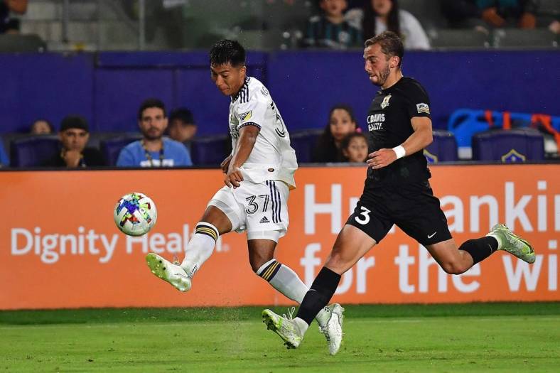Jun 21, 2022; Carson, CA, United States; Los Angeles Galaxy midfielder Daniel Aguirre (37) passes the ball ahead of Sacramento Republic FC defender Damia Viader (3) during the second half at Dignity Health Sports Park. Mandatory Credit: Gary A. Vasquez-USA TODAY Sports