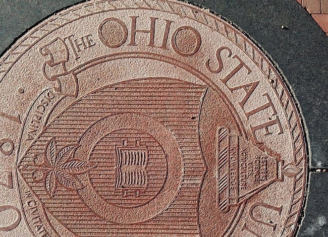 Ohio State University regularly uses the definitive article "The" in front of its name, as seen here in the university seal embedded in the pavement at the east entrance to the Oval on the main campus in Columbus.

The Ohio State University