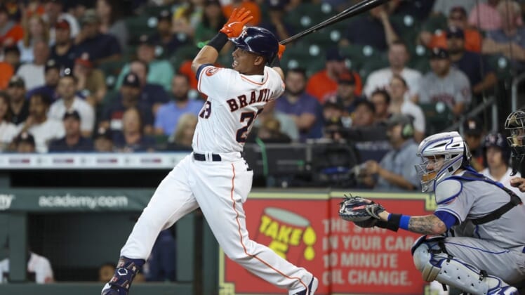 Jun 22, 2022; Houston, Texas, USA; Houston Astros designated hitter Michael Brantley (23) hits an RBI double against the New York Mets in the first inning at Minute Maid Park. Mandatory Credit: Thomas Shea-USA TODAY Sports