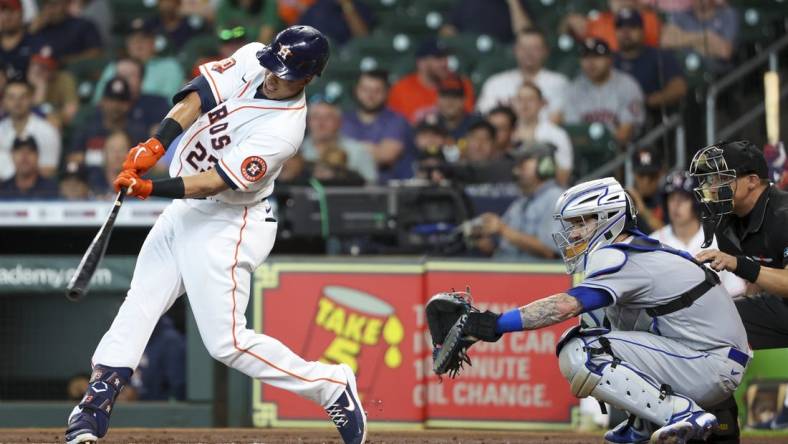 Jun 22, 2022; Houston, Texas, USA; Houston Astros designated hitter Michael Brantley (23) hits an RBI double against the New York Mets in the first inning at Minute Maid Park. Mandatory Credit: Thomas Shea-USA TODAY Sports