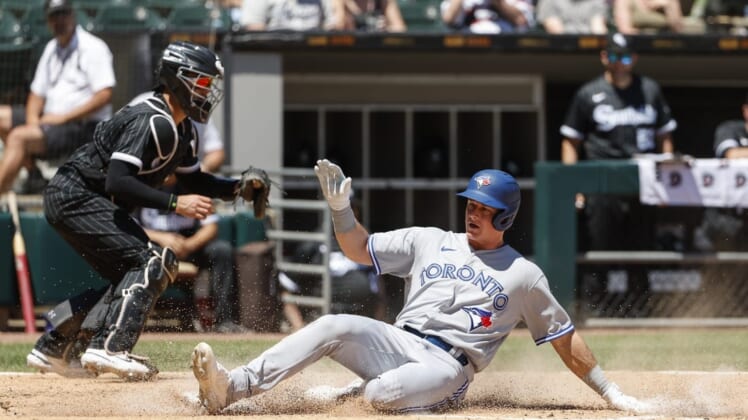 Jun 22, 2022; Chicago, Illinois, USA; Toronto Blue Jays third baseman Matt Chapman (26) slides safely into home as Chicago White Sox catcher Reese McGuire (21) is unable to tag him out during the fourth inning at Guaranteed Rate Field. Mandatory Credit: Kamil Krzaczynski-USA TODAY Sports