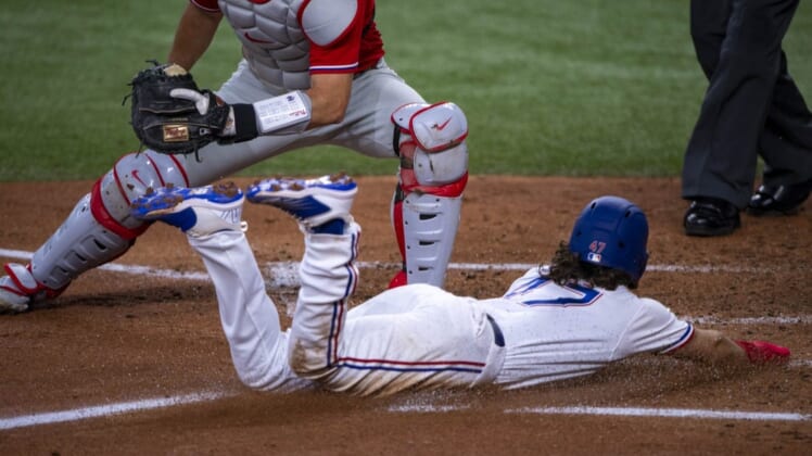 Jun 22, 2022; Arlington, Texas, USA; Texas Rangers left fielder Josh Smith (47) slides into home plate and scores against the Philadelphia Phillies during the second inning at Globe Life Field. Mandatory Credit: Jerome Miron-USA TODAY Sports
