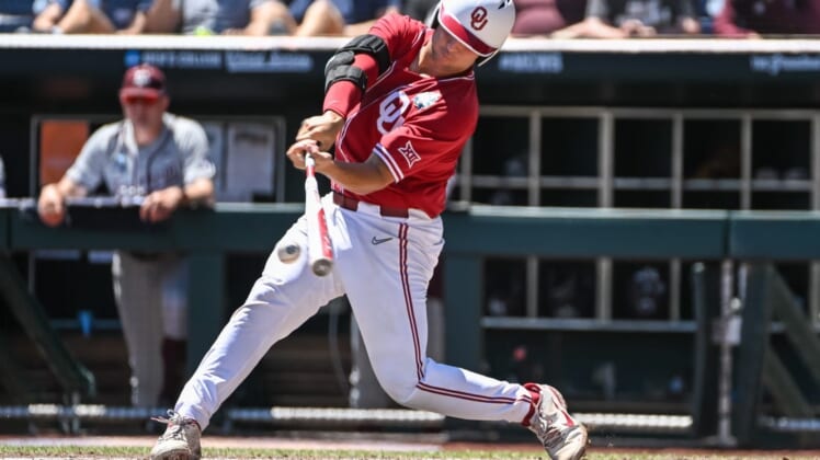 Jun 22, 2022; Omaha, NE, USA; Oklahoma Sooners catcher Jimmy Crooks (3) singles in the third inning against the Texas A&M Aggies at Charles Schwab Field. Mandatory Credit: Steven Branscombe-USA TODAY Sports
