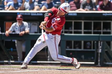 Jun 22, 2022; Omaha, NE, USA; Oklahoma Sooners catcher Jimmy Crooks (3) singles in the third inning against the Texas A&M Aggies at Charles Schwab Field. Mandatory Credit: Steven Branscombe-USA TODAY Sports