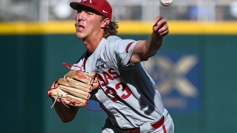 Jun 22, 2022; Omaha, NE, USA; Arkansas Razorbacks starting pitcher Hagen Smith (33) throws against the Ole Miss Rebels in the first inning at Charles Schwab Field. Mandatory Credit: Steven Branscombe-USA TODAY Sports