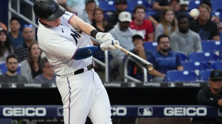 Jun 22, 2022; Miami, Florida, USA; Miami Marlins designated hitter Garrett Cooper (26) connects for a two-run home run in the third inning against the Colorado Rockies at loanDepot park. Mandatory Credit: Jasen Vinlove-USA TODAY Sports