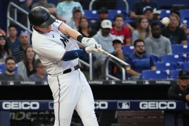 Jun 22, 2022; Miami, Florida, USA; Miami Marlins designated hitter Garrett Cooper (26) connects for a two-run home run in the third inning against the Colorado Rockies at loanDepot park. Mandatory Credit: Jasen Vinlove-USA TODAY Sports