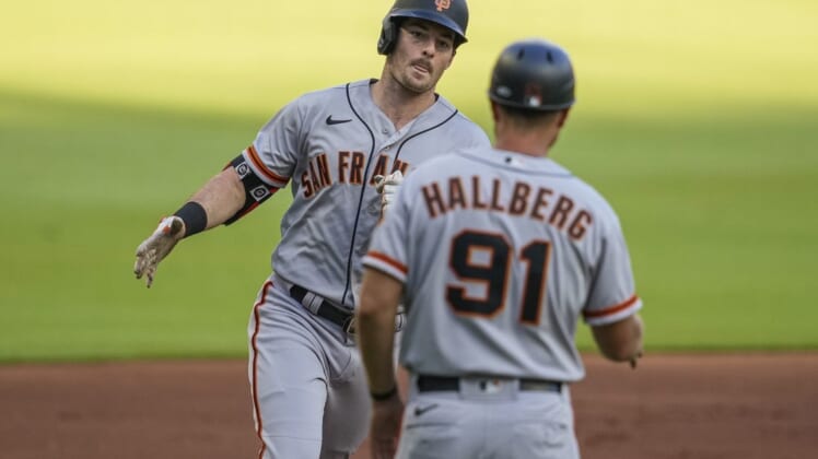 Jun 22, 2022; Cumberland, Georgia, USA; San Francisco Giants Mike Yastrzemski (5) reacts with third base coach Mark Hallberg (91) after hitting a home run against the Atlanta Braves during the first inning at Truist Park. Mandatory Credit: Dale Zanine-USA TODAY Sports