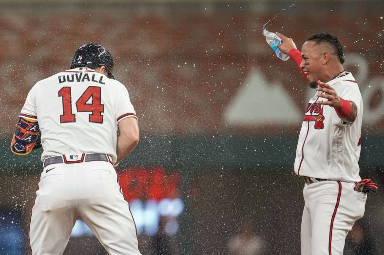 Jun 22, 2022; Cumberland, Georgia, USA; Atlanta Braves left fielder Adam Duvall (14) celebrates with Orlando Arcia (11) after driving in the game winning run against the San Francisco Giants during the ninth inning at Truist Park. Mandatory Credit: Dale Zanine-USA TODAY Sports