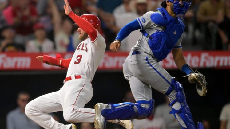 Jun 22, 2022; Anaheim, California, USA;  Los Angeles Angels right fielder Taylor Ward (3) scores a run past Kansas City Royals catcher MJ Melendez (1) in the fifth inning of the game at Angel Stadium. Mandatory Credit: Jayne Kamin-Oncea-USA TODAY Sports