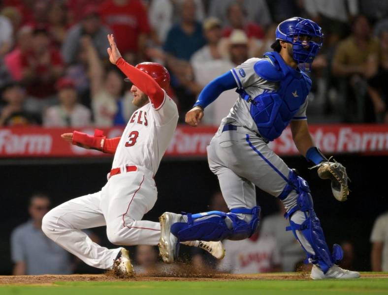 Jun 22, 2022; Anaheim, California, USA;  Los Angeles Angels right fielder Taylor Ward (3) scores a run past Kansas City Royals catcher MJ Melendez (1) in the fifth inning of the game at Angel Stadium. Mandatory Credit: Jayne Kamin-Oncea-USA TODAY Sports
