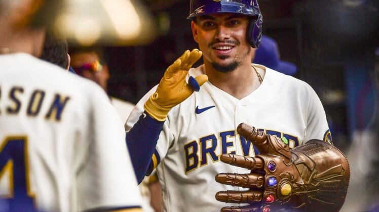 Jun 23, 2022; Milwaukee, Wisconsin, USA; Milwaukee Brewers shortstop Willy Adames (27) celebrates in the dugout after hitting a solo home run in the fifth inning against the St. Louis Cardinals at American Family Field. Mandatory Credit: Benny Sieu-USA TODAY Sports